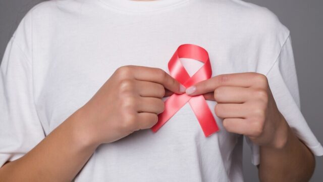 world-breast-cancer-day-concept-health-care-woman-wore-white-t-shirt-with-pink-ribbon-awareness-symbolic-bow-color-raising-people-living-with-women-s-breast-tumor-illness