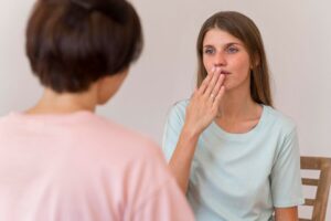 two-women-having-conversation-with-each-other-by-using-sign-language