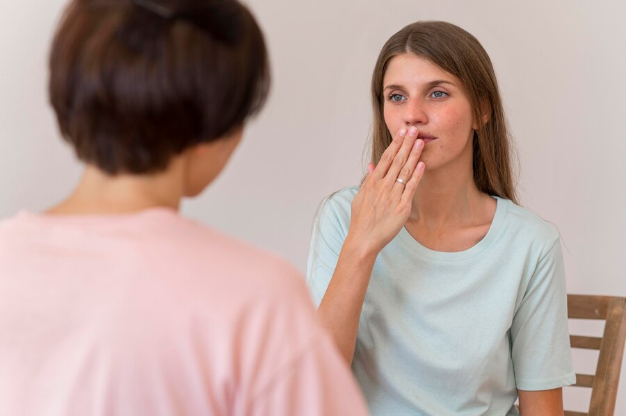 two-women-having-conversation-with-each-other-by-using-sign-language