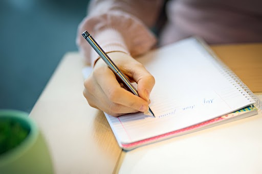 Image of a student paying someone to write an assignment online, showcasing professional academic help.